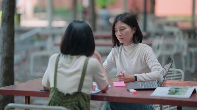 Serious misunderstanding between two asian scholars creating tension and anger during outdoor lecture preparation caused by lack of sleep and overwhelming study schedule requirements today