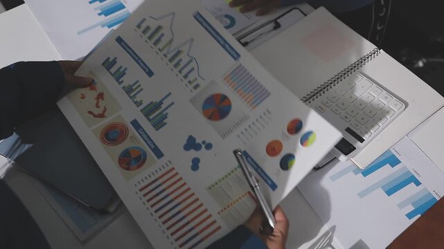 Asian male financial officer or accountant checking investment results Financial budget analysis Planning to summarize results and report to the meeting Audit concept and investment results.