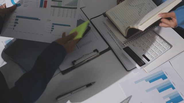 Asian male financial officer or accountant checking investment results Financial budget analysis Planning to summarize results and report to the meeting Audit concept and investment results.