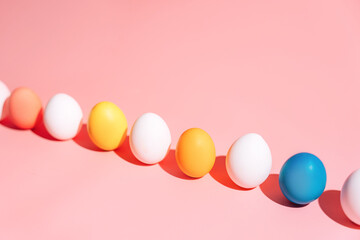 Row of Easter eggs on pink background with copy space, minimal banner. High quality photo