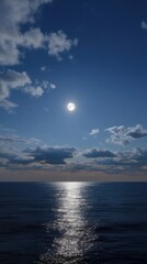 Obraz premium Dramatic Vertical View of Shining Moonlight Through Cloud Layers Over Ocean
