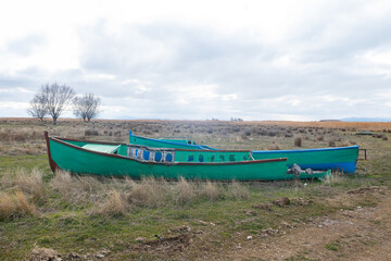 Abandoned old fishing boats in the middle of the steppe. A story of loneliness, nostalgia, and a dried-up lake bed.