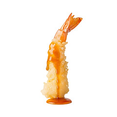 A succulent shrimp tempura stands upright with a savory sauce dripping down its crispy exterior