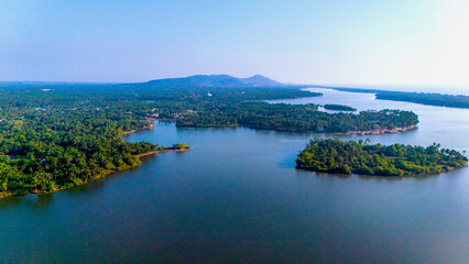 Fototapeta premium Mesmerizing aerial view of the Kavvayi backwaters and island network near Payyanur, the largest backwater lake in North Kerala.
