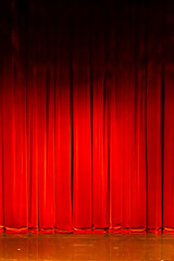 Red velvet curtain closing theater stage before performance