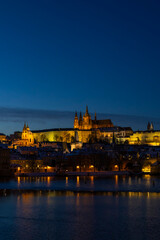 Obraz premium Prague Castle and Old Town city skyline glowing at night over Vltava River, Czechia