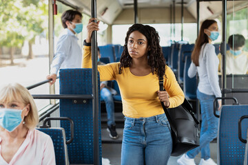 Portrait of irresponsible young African American woman ignores public rules during a viral disease...