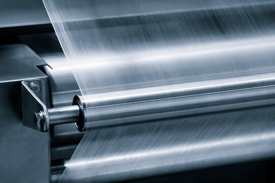 Automatic polyethylene plastic bag production machine with lighting effect. Close-up roller plastic bag production machine light blue scene. product packaging concept