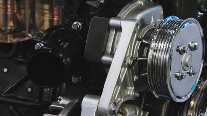 Beautiful modern car engine close-up, the engine is new and shiny made of stainless steel with...