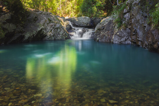 An idyllic natural pool at Cougal Cascade in Springbrook National Park in the tropical rainforest of Queensland, Australia.