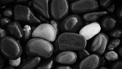 Fototapeta premium Wet Pebbles stones on seashore as texture background for design web banner template page. SPA concept background