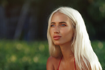Naklejka premium Pensive Blonde Woman in Nature During Golden Hour