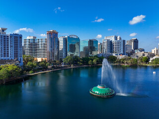 Fountain at Lake Eola with high-rises in background at downtown Orlando in Orange County, Florida.