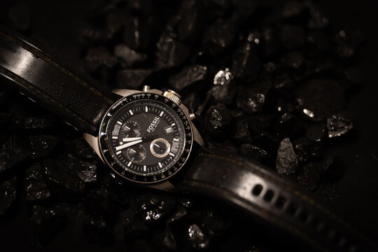 Bucharest Romania 18 January 2026.Stylish Fossil men&rsquo;s wristwatch displayed on a textured background of black stones. Elegant timepiece product photo highlighting luxury.
