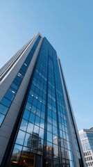 Obraz premium Modern Glass Building Against Clear Sky in Urban Landscape