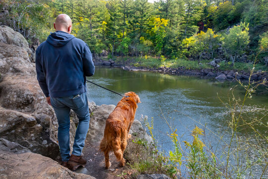 Autumn Walk Along the Saint Croix River - A Man and His Dog Exploring a Scenic Forest Trail
