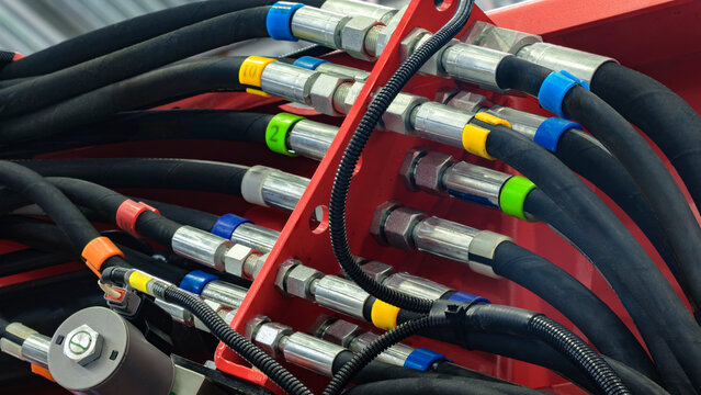 Bundle of pipes connected to industrial hydraulic pneumatic machine, industrial concept