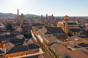 Bologna Italy cityscape with historic towers and terracotta rooftops under a clear sky © ronnybas