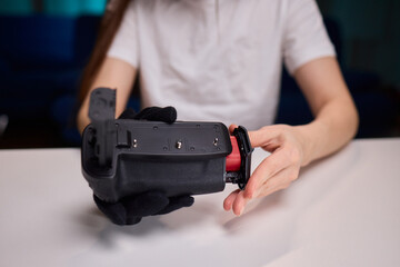 Camera power supply setup process, Connecting battery pack carefully into camera housing for filming, Unboxing and installing power source into camera in studio setting