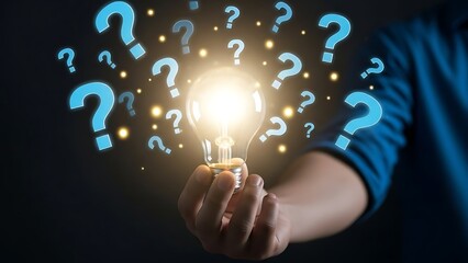 Innovative Idea and Problem Solving Concept with Person Holding Glowing Light Bulb Surrounded by Floating Question Marks