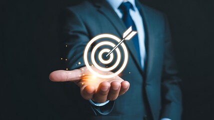 Businessman Holding a Glowing Target Symbol in a Professional Setting for Successful Targeting and Strategic Objectives