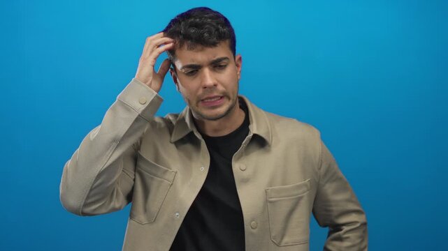 Man with hand on head for thinking in studio; confusion hesitation.