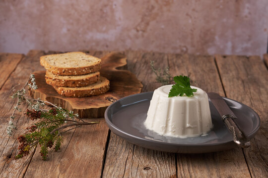 Fresh Cheese From Burgos Served With Bread on Wooden Table