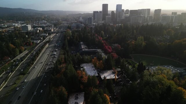Aerial Drone View of Bellevue Downtown Skyline and Interstate Highway Through Autumn Forest