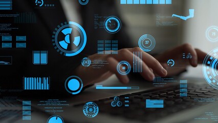 A person hands typing on a laptop surrounded by abstract digital data visualization elements, representing technology and business analytics in a modern office environment. Xenic