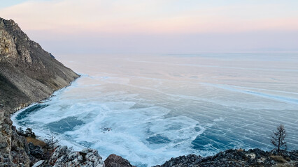 a view from the top of the mountain of the beautiful smooth and cracked ice of Lake Baikal