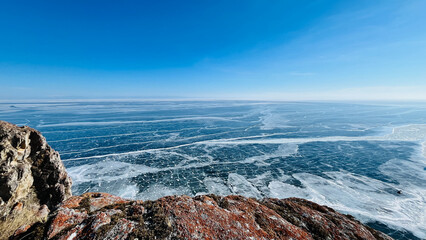 a view from the top of the mountain of the beautiful smooth and cracked ice of Lake Baikal