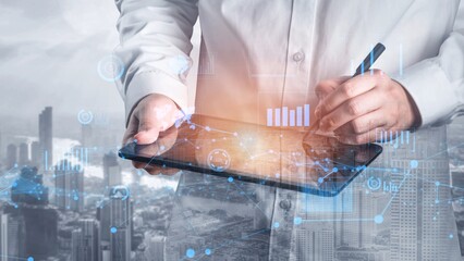 A professional uses a digital tablet for data analysis, surrounded by futuristic graphics and overlooking a vibrant city skyline, showcasing technology and innovation. Xenic