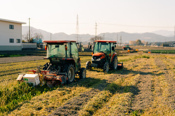 Obraz premium two tractors in a field used for agricultural work