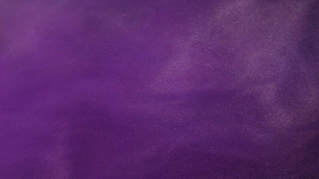 Acrylic fluid. Wet texture. Defocused purple color grain paint in water chemical flow spreading on abstract art creative background.