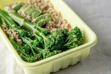 Minimalist takeout meal prep containers with quinoa, green broccolini