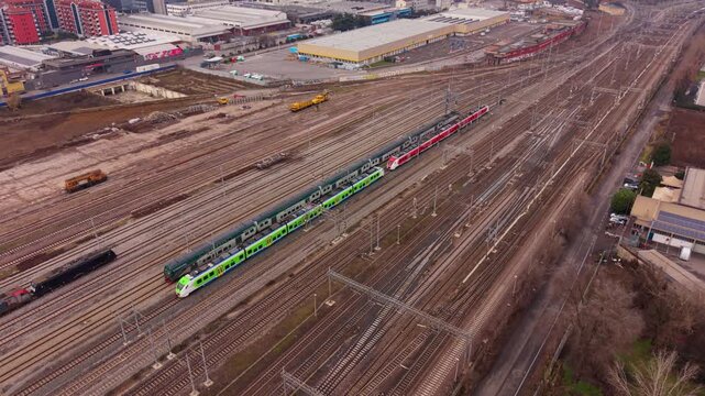 Railway Station Scene: An aerial view showcases the operational intensity of a railway station, with multiple tracks, trains, and infrastructural elements.
