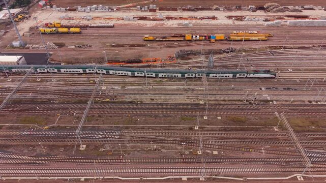 Trainyard Panorama: An elevated perspective presents a railway station, alive with the movement of trains, tracks, and infrastructure.