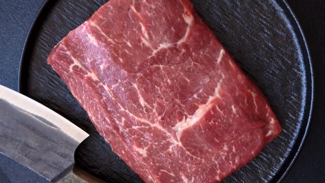 A piece of raw beef, a tenderloin for grilling or barbecue. Raw beef as a food background for your design