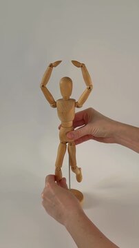  Wooden mannequin takes first steps, moving like a poseable figure. This articulated mannequin and wooden model captures realistic movement, perfect for artists and dynamic sketches.
