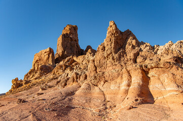 Fototapeta premium View of mountains at sunset. Lunar landscapes at golden hour in Teide National Park, Tenerife, Canary Islands, Spain. Unique volcanic formations. Geological and travel concept.