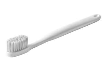 Minimalist manual toothbrush lying flat on a clean surface during daylight