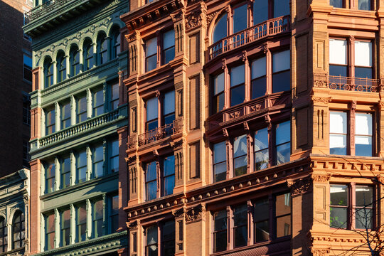 Cast-iron and brick facades along Broadway in the NoHo Historic District of Lower Manhattan, featuring architectural detail. New York City, USA