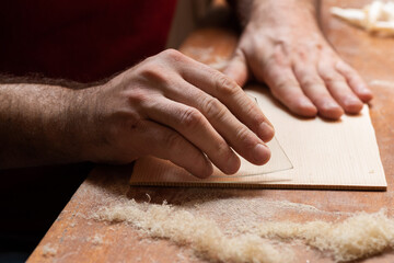 The master cycles the surface of the spruce board