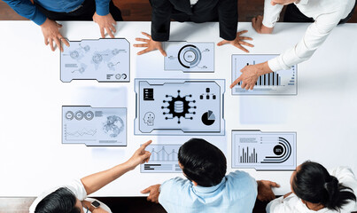 A dynamic business team collaborates on data analysis using digital touch screens filled with graphs and charts. They explore insights in a sleek office setting. Trope