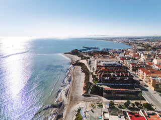 Aerial view of Torre de la Horadada townscape with Mediterranean Sea view during sunny day. Spanish resort, travel and touristic places concept. Costa Blanca, Alicante province, Spain 