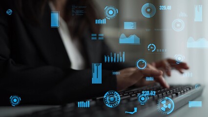 A business professional uses a keyboard while engaging with digital data visualization graphics in a contemporary office setting, showcasing the importance of technology in decision-making. Xenic