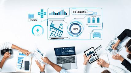 A digital dashboard displays data visualizations for managing electric vehicle charging stations, highlighting technology, teamwork, and business analysis. Trope