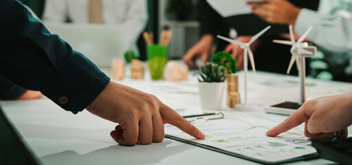 A dynamic business meeting in a modern office setting where team members collaborate on project plans, focusing on innovative and sustainable solutions for future growth. SACTR