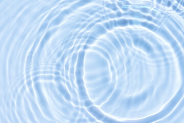 Obraz na płótnie Canvas Water background,Wave surface for cosmetic summer banner,Blue water on swimming pool with circle pattern motion,abstract white light effect,Top view water splash texture by sea beach or bathroom 