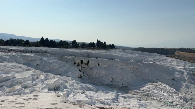Explore the stunning white travertine terraces of Pamukkale, a UNESCO World Heritage site, where mineral-rich thermal waters flow and refresh visitors.